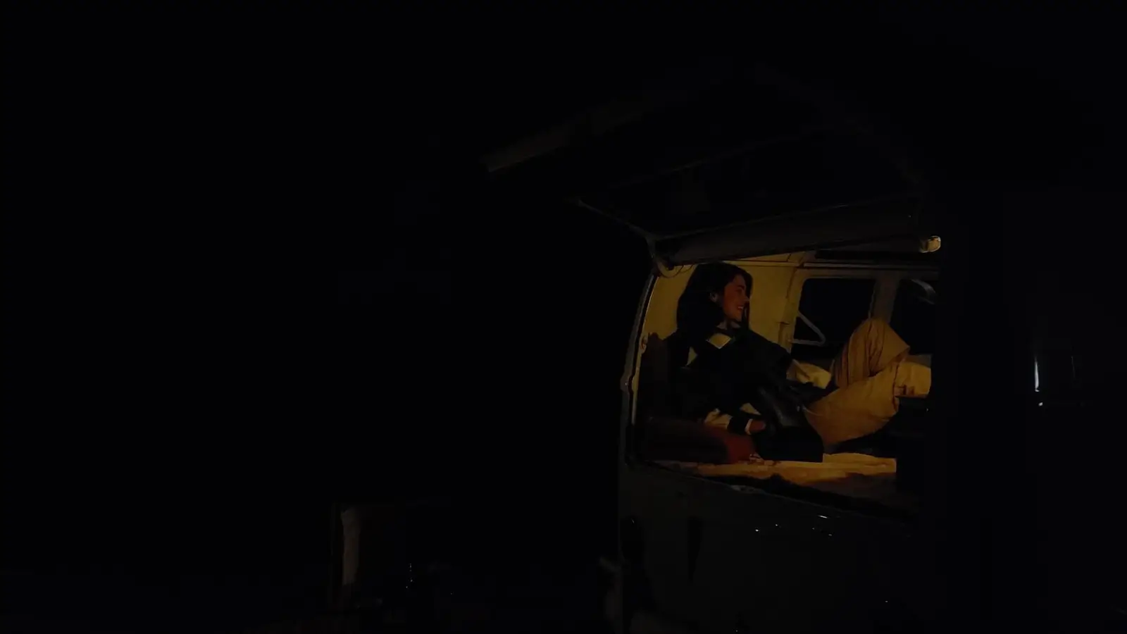 Without Night mode: a camper van at night, almost black, a dim light inside