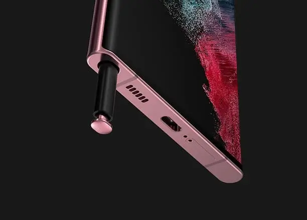 The S Pen sliding out of the bottom edge of a Burgundy Galaxy S22 Ultra
