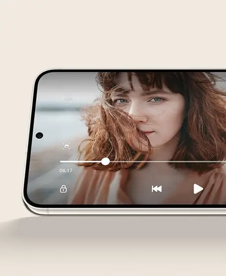 A Galaxy S23 series phone held sideways, playing a video of a woman with windswept hair