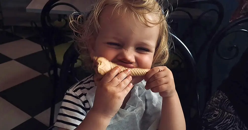 The same photo remastered: brighter and sharper, the toddler's face and hands clear