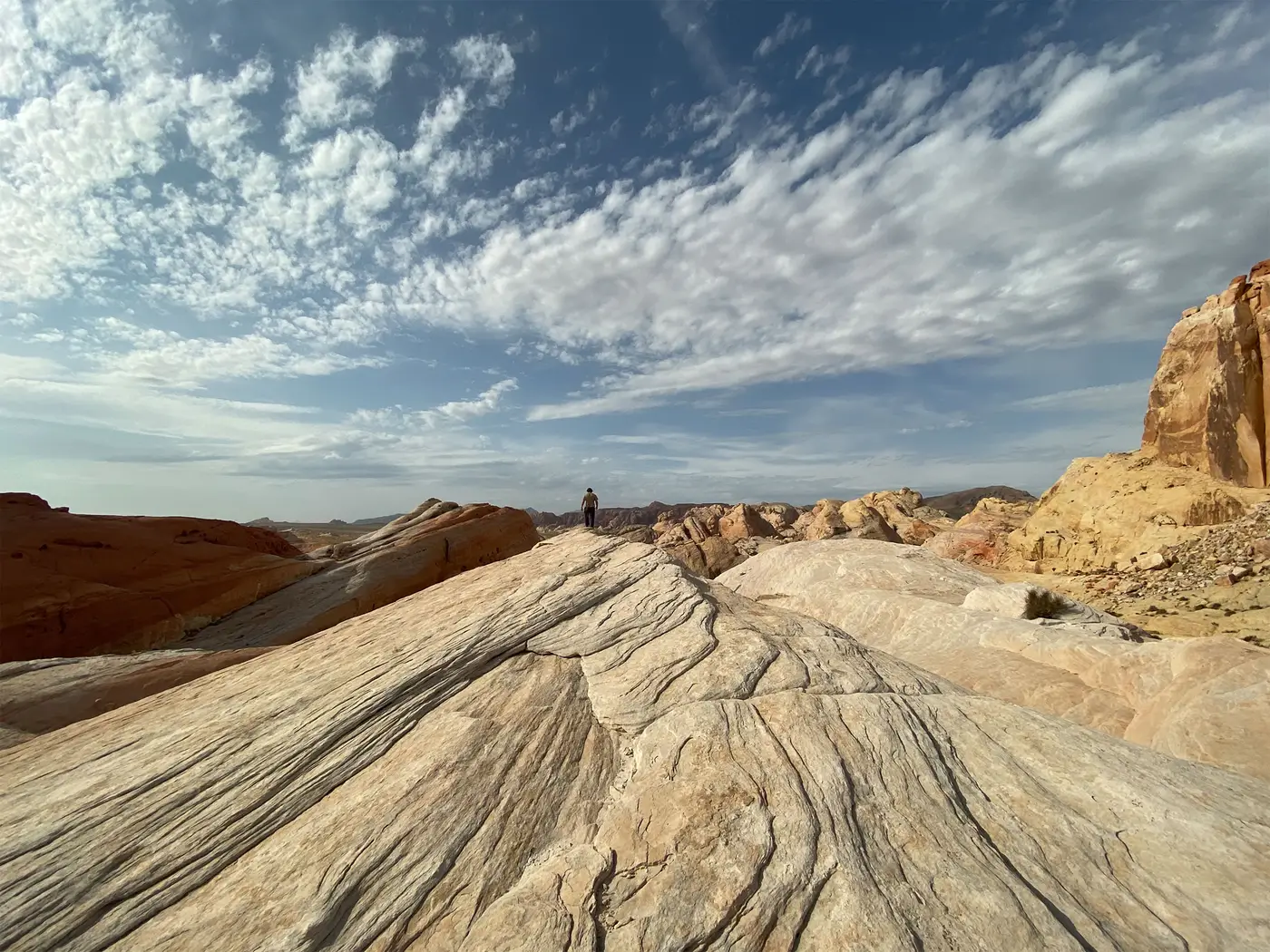 Wide rippled sandstone rocks under a sky full of clouds