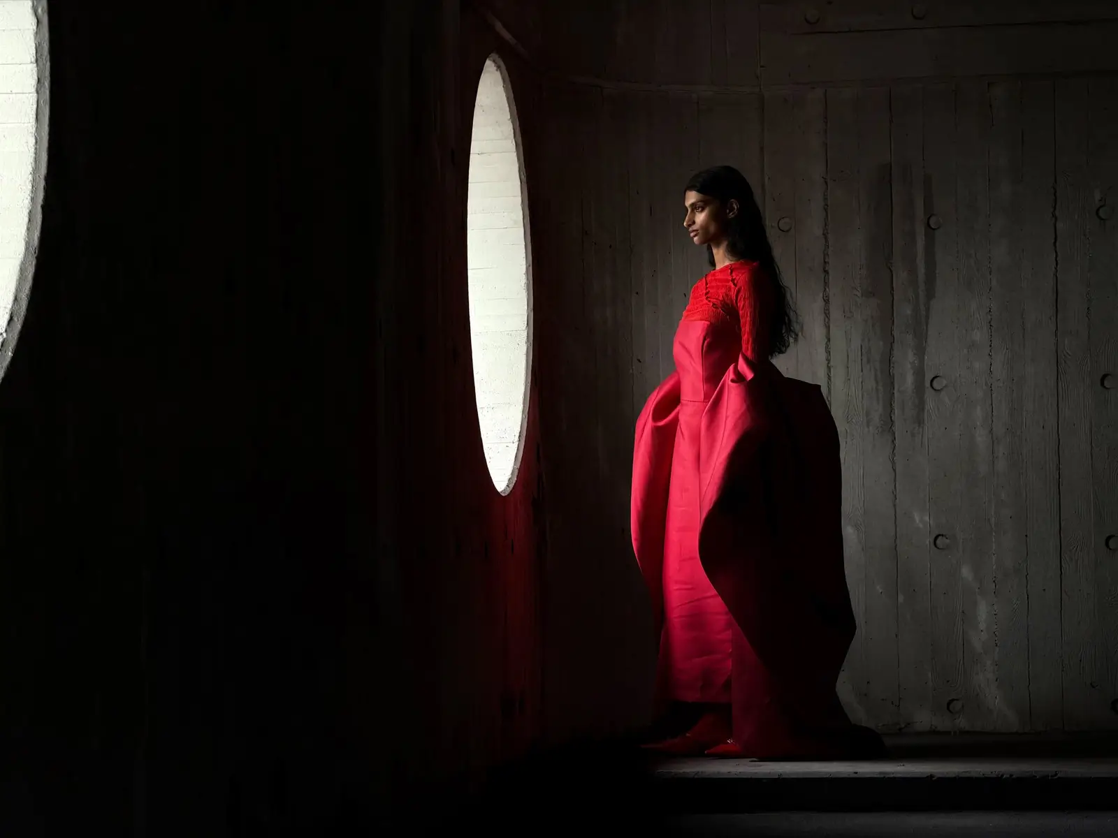 At 100 mm a full-length portrait of the person in the red gown against concrete