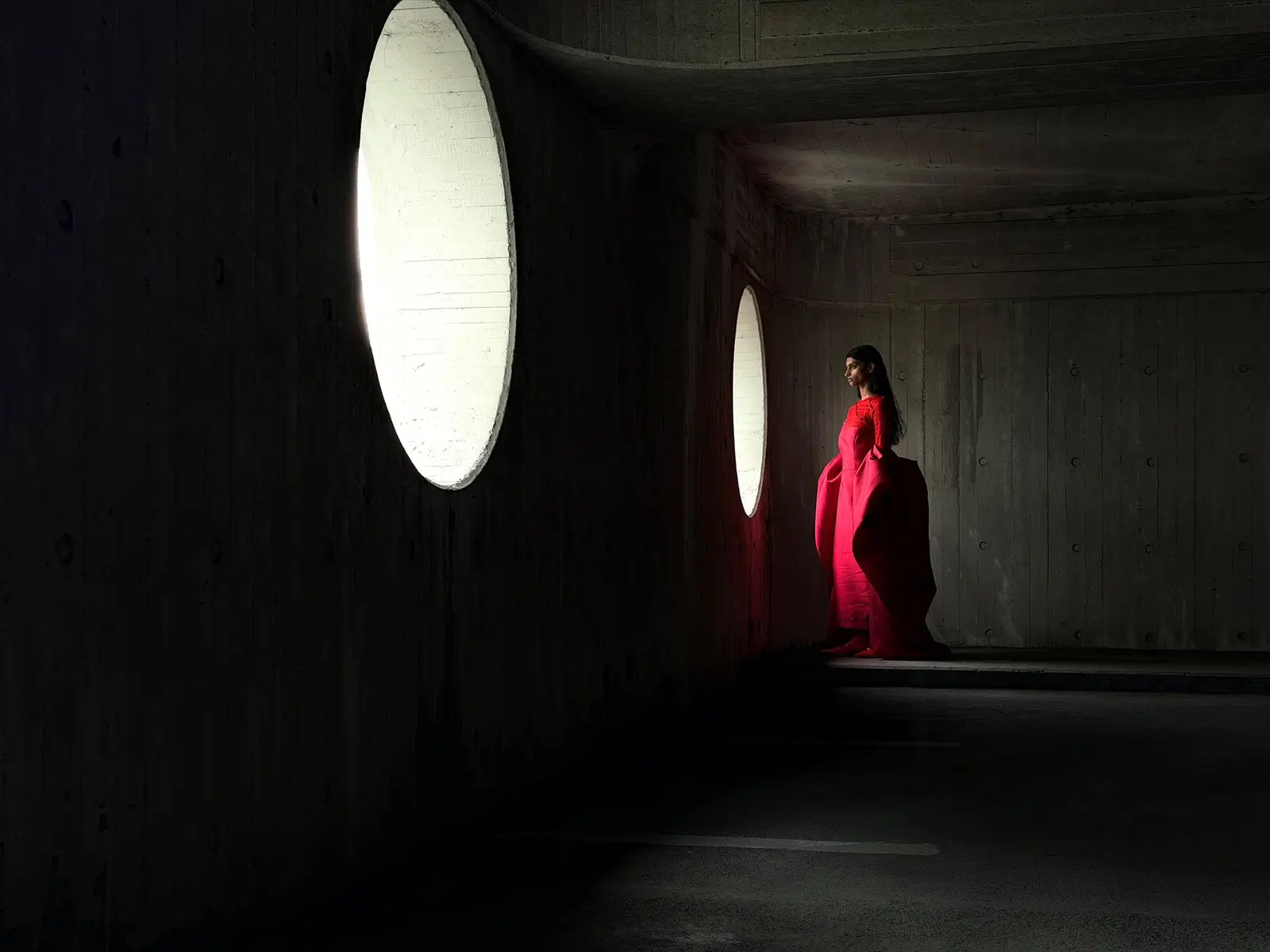 At 48 mm the red gown fills more of the frame next to the window
