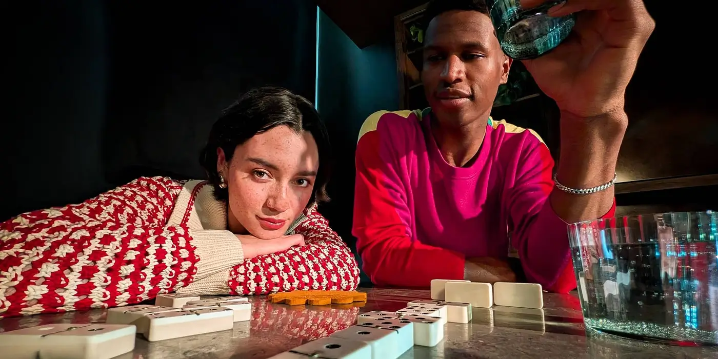Ultra Wide: two people pose at a table while playing dominoes