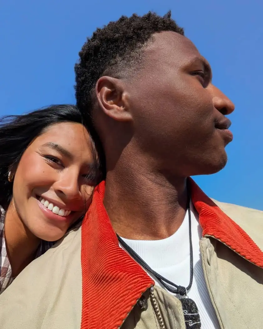 Ultra Wide: a woman rests her head on a man's shoulder under a wide blue sky