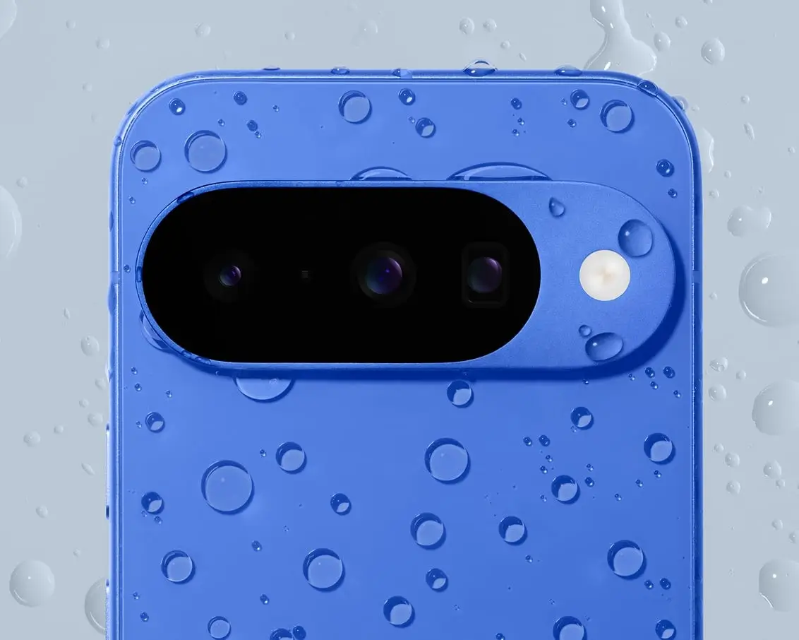 The camera bar and back of an Indigo Pixel 10 dotted with water droplets