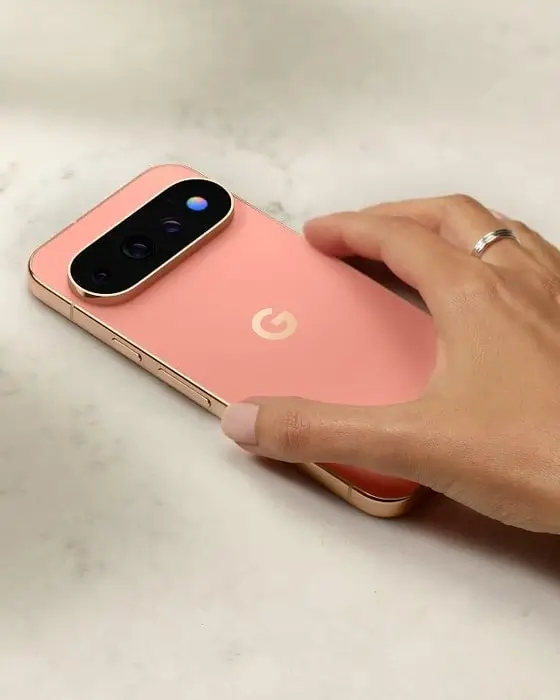 A hand rests on a Canyon Pixel 11 Pro phone lying on a marble surface