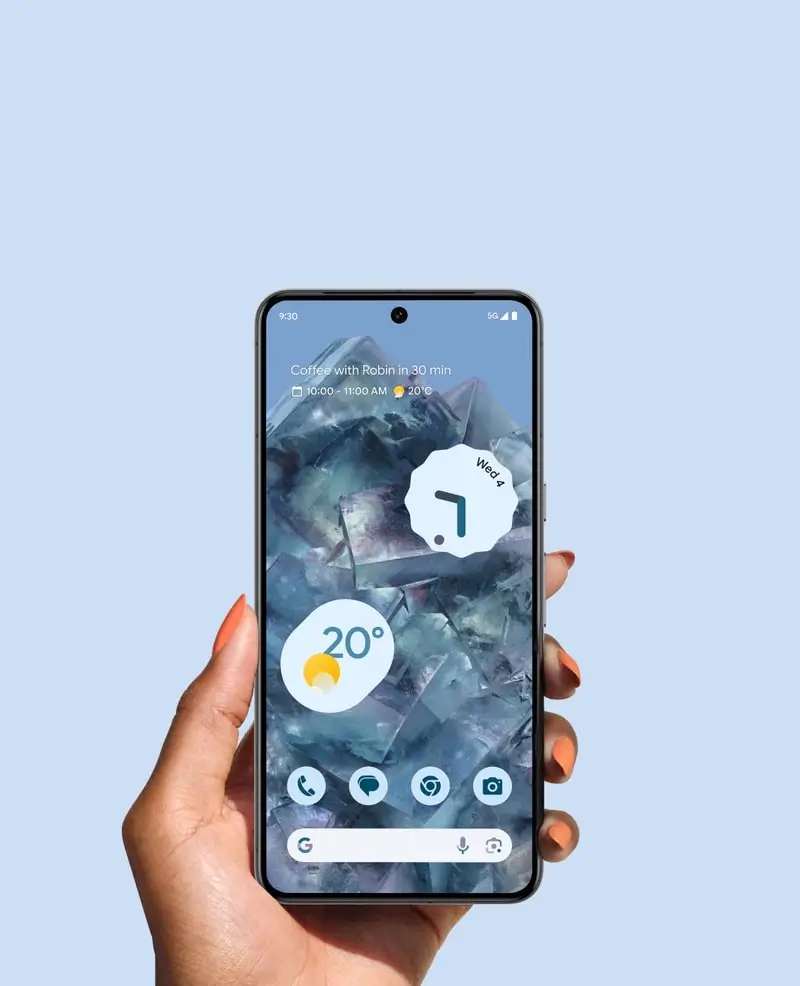 A hand holds a Bay Pixel 8 Pro, its home screen showing the time and weather